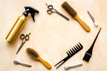 Hairdressing mockup - with brush, spray and sciccors - on beige background top-down frame copy space