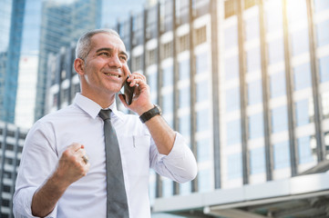 Portrait of senior businessman talking on phone