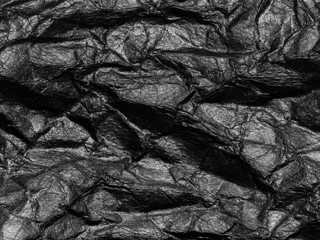 Black crumpled paper texture background. Copy space for design and artwork