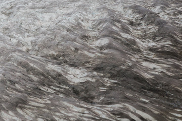 polluted surface of Swiss Aletsch glacier with crevasses