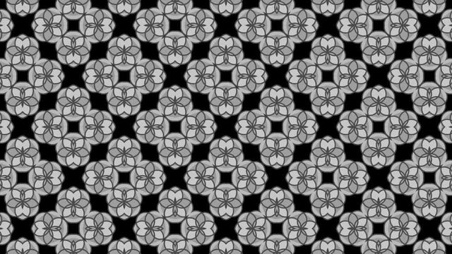 Graphic motif in black and white composed of floral motifs with stroboscopic and hypnotic effect, which rotates clockwise and increases in size