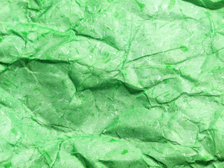 Pattern of green crumpled paper texture background.