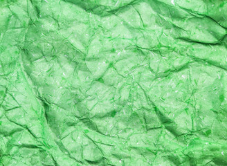 Pattern of green crumpled paper texture background.