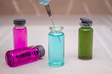 beakers with color solutions and syringe