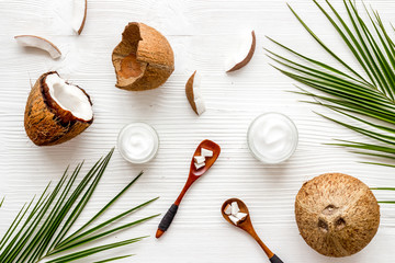 Homemade coconut cream - still life with spoon - on white wooden background top-down