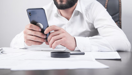 Man using smartphone. Modern office desk. Technology