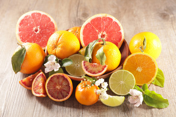 citrus fruit assortment, grapefruit, orange, lemon and leaf