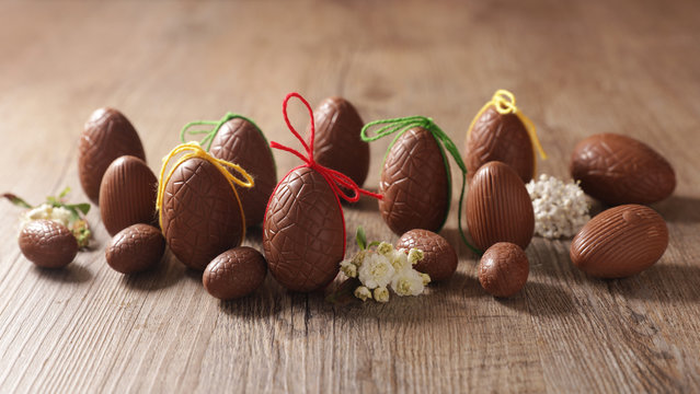 chocolate easter egg and bow on wood background