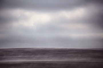 Obraz premium smoke in the field and cloudy sky