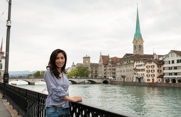 Fototapeta na wymiar Europe city woman traveller lifestyle. Travel Europe summer holiday girl enjoying her holiday. Young Asian Girl relaxing in Europe city. Vacation and Holidays in Zurich and Europe concept.
