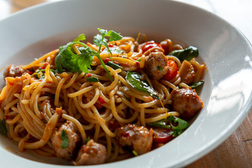 Selective focus, Spaghetti pasta with meatballs and tomato sauce. spaghetti and meatballs with oregano garnish on white plate. Spicy Spaghetti pasta with meatballs and spicy sauce.