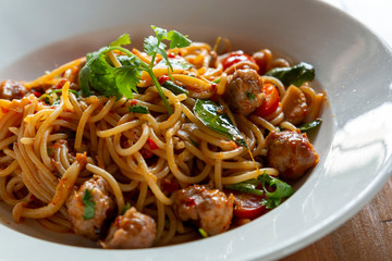 Selective focus, Spaghetti pasta with meatballs and tomato sauce. spaghetti and meatballs with oregano garnish on white plate. Spicy Spaghetti pasta with meatballs and spicy sauce.