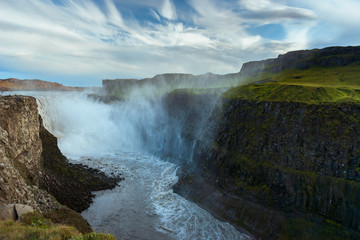 Fototapeta premium Beautiful Icelandic waterfall at sunset with huge quantity of flowing waters Iceland
