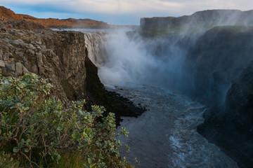 Beautiful Icelandic waterfall at sunset with huge quantity of flowing waters Iceland