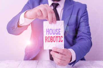 Word writing text House Robotic. Business photo showcasing Programmable powered machines that perform household chores Man holds empty paper with copy space in front of him Copy Space