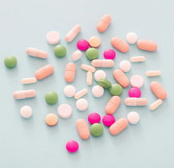 Medicine pills and capsules on pastel blue background. Health pharmacy concept