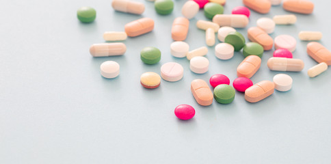 Medicine pills and capsules on pastel blue background. Health pharmacy concept