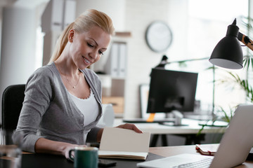 Young woman at work. Beautiful businesswoman working in office.