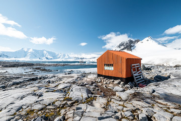 mountain hut in the snow on the shore of antarctica close to port lockroy 