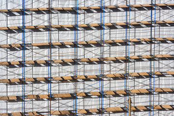 Scaffolding background on a construction site. Spring sunny day