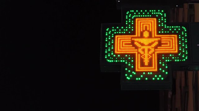 Pharmacy symbol. Italian green cross, pharmacy in Milano.