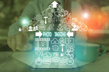 Conceptual hand writing showing Photo Tagging. Concept meaning identify someone on the photo that...