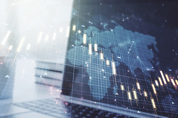 Multi exposure of abstract creative financial chart with world map on laptop background, research and analytics concept