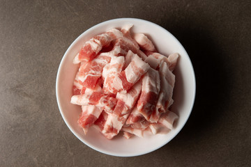 Fresh raw pork in white bowl