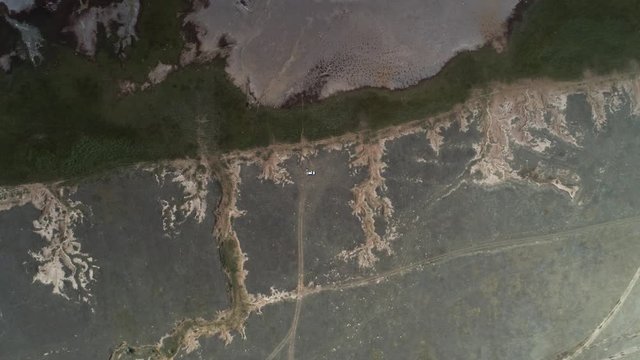 Aerial shot of soil erosion. Bank oa salt lake. Altai. Bursol. Russia. August 2019 