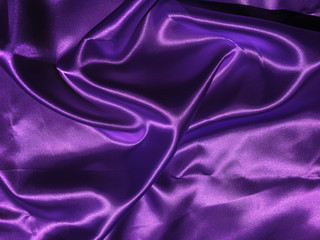 Fototapeta na wymiar Smooth purple fabric or satin texture background with copy space for design