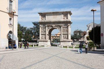 Fototapeta na wymiar Benevento, Campania, Italy: people walking near the arch of Trajan
