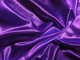Smooth purple fabric or satin texture background with copy space for design