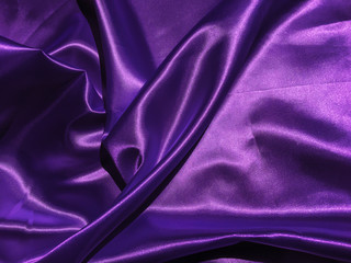 Smooth purple fabric or satin texture background with copy space for design