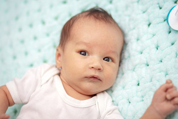 Portrait of a little newborn baby on the couch. Cute baby