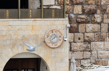Wall clock with the designation of 12 Jewish tribes hang on the wall near the Western Wall near the...