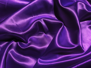 Obraz premium Pattern of purple fabric texture background. wavy folds of grunge silk texture satin velvet material for design
