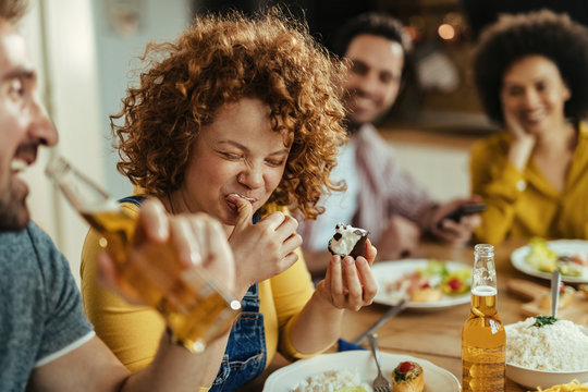 Young Woman Having Fun While Eating Dessert After Lunch With Friends At Dining Table.