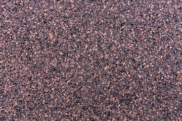 Closeup red and black bitumen shingles. Rough background made of roofing material