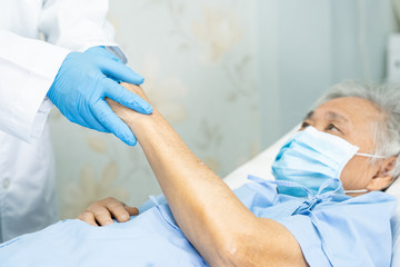 Doctor holding touching hands Asian senior or elderly old lady woman patient with love, care, helping, encourage and empathy at nursing hospital ward : healthy strong medical concept