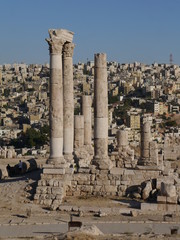 close up on famous ruins of  ancient Hercules temple on top citadel hill (Jebel el Qala'a) city of  Amman in the background, kingdom Jordan, Middle East