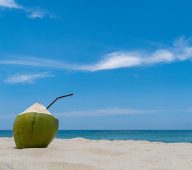 Refreshing coconut on a beautiful sandy beach