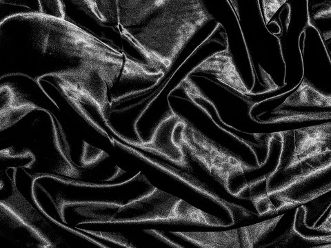 Black cloth or fabric exture background with liquid wave or wavy folds. Wallpaper design