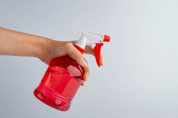 Naklejka premium spray bottle in hand, isolated on white background