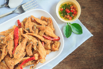 Crispy fish on a wooden table served