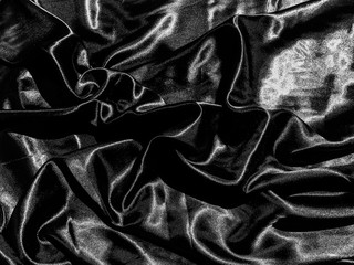 Black satin texture background with liquid wave or wavy folds. Wallpaper design