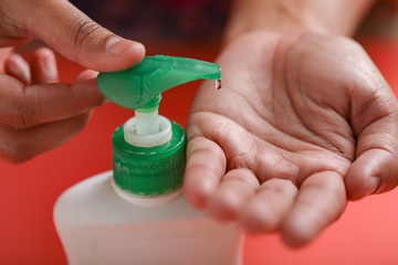 Woman washes her hands using liquid soap to protect corona virus