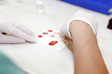 Scientist working in his laboratory. A blood test is a laboratory analysis performed on a blood...
