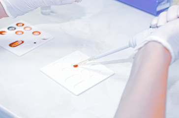 Scientist working in his laboratory. A blood test is a laboratory analysis performed on a blood...