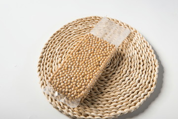 Fresh soybeans isolated on a white background, top view wooden bowl