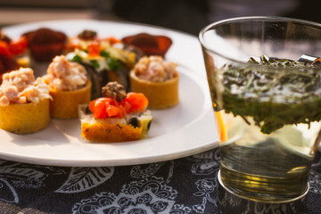 savoury afternoon tea items such as tuna tarts, sushi, salmon  sandwiches, chocolate pralines on a river cruise in Xixi Wetland, Hangzhou China